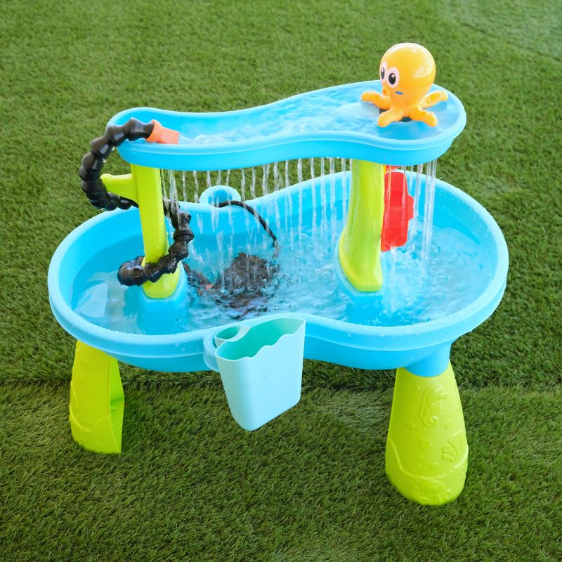 Children's water play set with slides and pool on a grass background