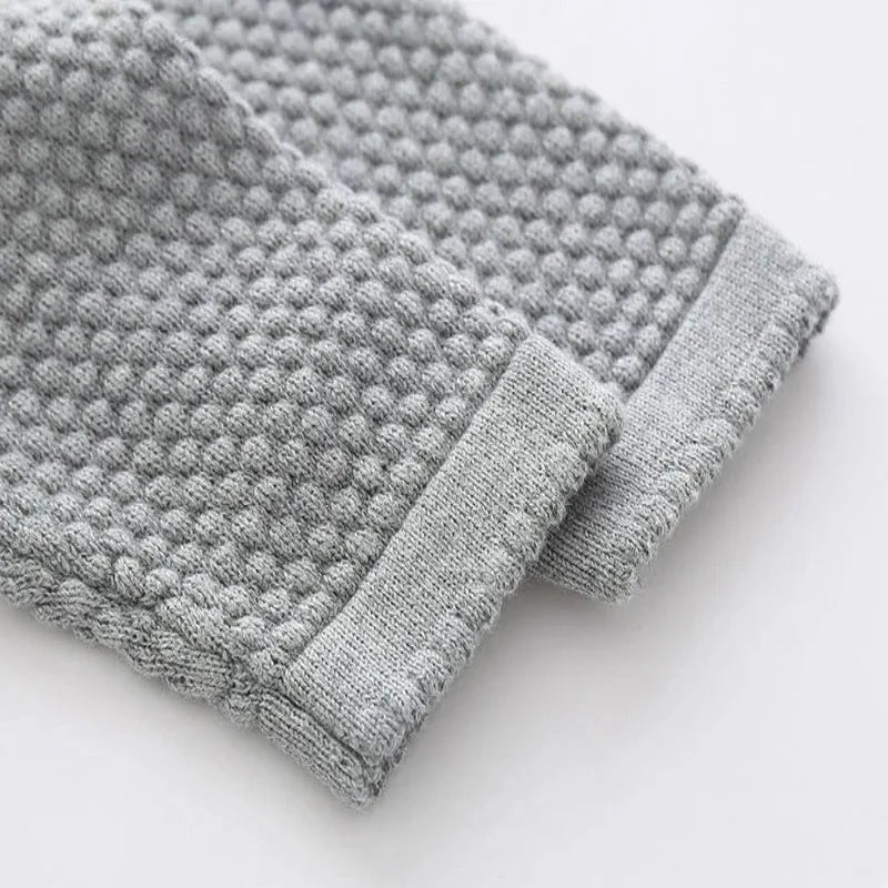 Close up of grey sweater sleeves