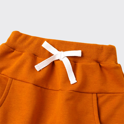 Close up of orange joggers waistband