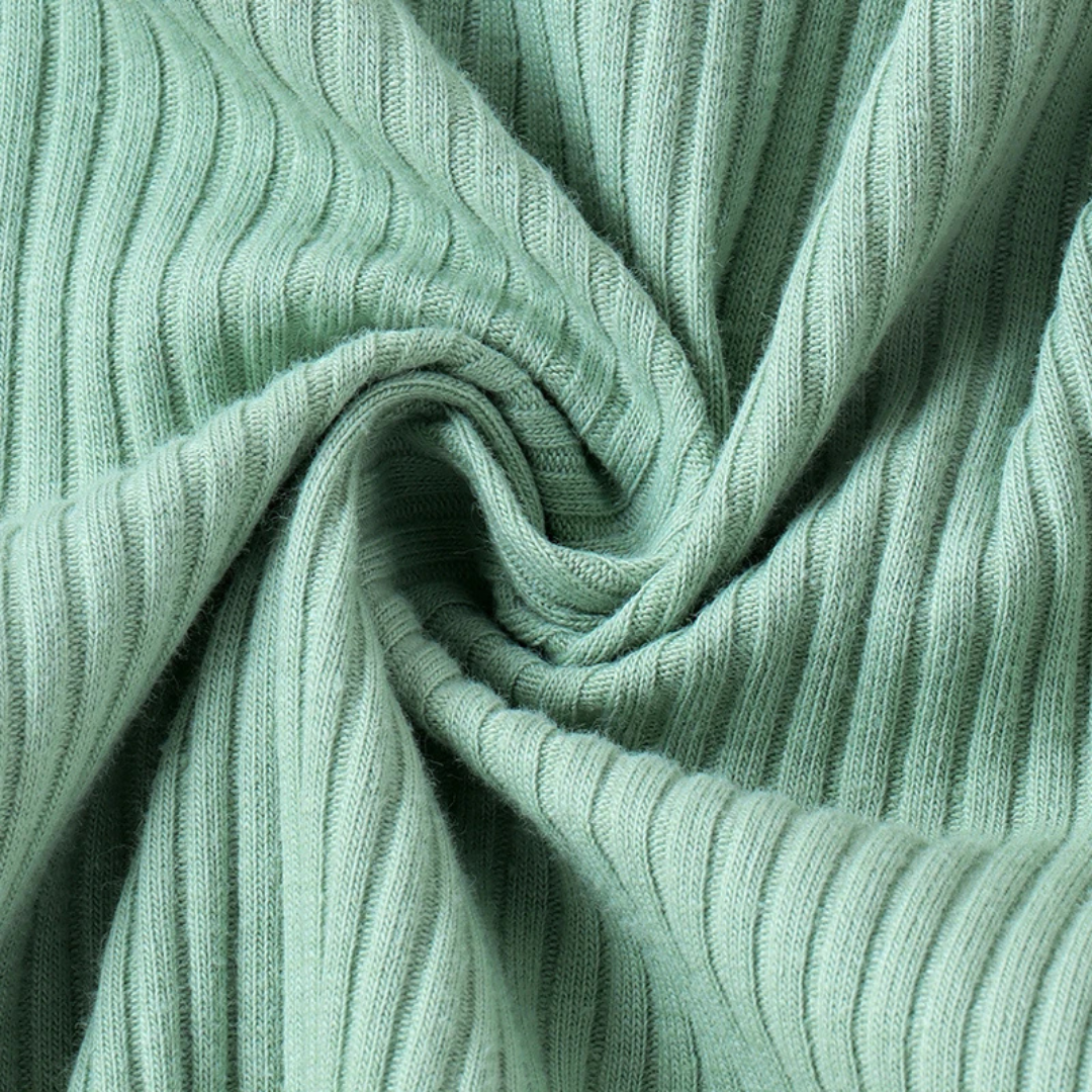 Long sleeve ruffle romper in green close up of fabric