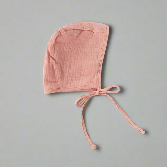 Pink colored muslin bonnet side profile